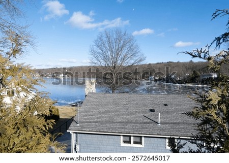Similar – Image, Stock Photo Partly frozen lake with a view of the snow-covered fir forest