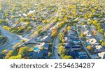 Lakeside upscale residential neighborhood along MacArthur boulevard in Coppell, suburbs Dallas, Texas, colorful fall foliage autumn leaves over two-story houses with swimming pool, large backyard. USA