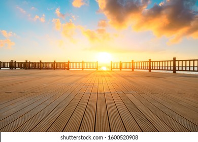 Lakeside Wood Floor Platform And Sky Clouds At Sunset.