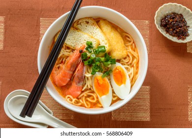Laksa is a popular spicy dish in the Peranakan cuisine, which is a combination of Chinese and Malay cuisine. It consists of rice noodles or rice vermicelli with chicken, prawn or fish in spicy soup.