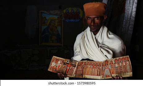 Lalibala/Ethiopia - 04/15/2019: Ethiopian Christian monk in Asheton Maryam Monastery in Amhara Region, Ethiopia,  shows ancient art held at the monastery