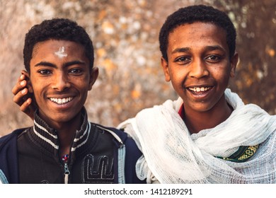 Lalibela, Ethiopia - November 04, 2018: Ethnic teen men standing together and smiling at camera in region of Lalibela, Ethiopia