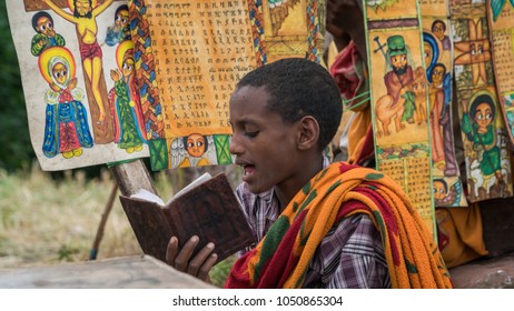 Lalibela, Ethiopia - September 2017: Unidentified pilgrim reading bible at one of the old rock churches from Lalibela