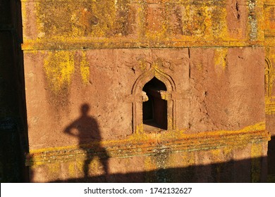 Lalibela / Ethiopian - 1 January 2020: Sunset Evening Golden Light Shadow Of A Man Sitting At St George's Church Bet Giyorgis New Yellow Window