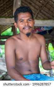 LAMALERA, NUSA TENGGARA, INDONESIA - DEC 13, 2018: Portrait of young adults male looking at the camera at lamalera, Indonesia