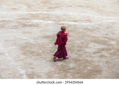 Lamayuru Gompa, Ladakh, India - june 14, 2015 : Young buddhist boy with a cup of drink in a monastery Lamayuru, Ladakh, North India