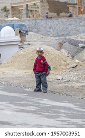 Lamayuru Gompa, Ladakh, India - june 16, 2015 : Young boy going home from school after lessons at the local school at Lamayuru Gompa, Ladakh, North India
