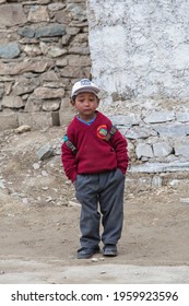 Lamayuru Gompa, Ladakh, India - june 16, 2015 : Young boy going home from school after lessons at the local school at Lamayuru Gompa, Ladakh, North India