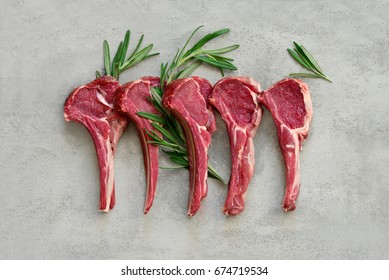 Lamb chops decorated with rosemary branches, view from above, flat lay - Powered by Shutterstock