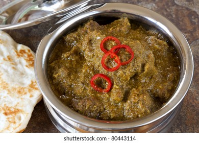 Lamb Korma Indian Curry In Serving Bowl, With Naan Bread.