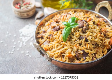 Lamb pilaf in a bowl on stone background with copy space