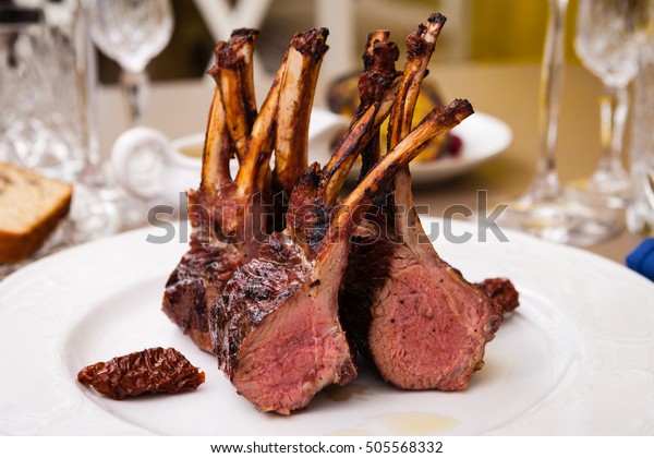 Lamb rack\
with limoncello glaze served on a\
plate