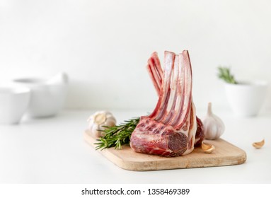 Lamb rack on kitchen cutting board, front view - Powered by Shutterstock