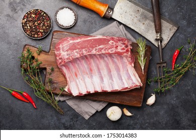 Lamb ribs cooking. Raw rack of lamb with spices and condiments. Top view - Powered by Shutterstock