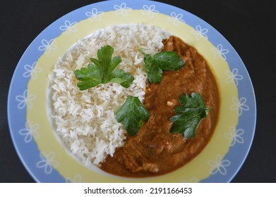 Lamb Rogan Josh Served With Rice And Parsley