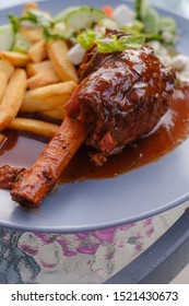 Lamb shank on a plate with salad