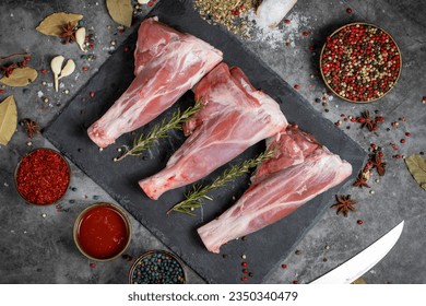Lamb shank. Raw lamb shank meat on dark background. Butcher products. Top view - Powered by Shutterstock