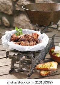 lamb slowly cooked in a traditional Greek way in a baking sheet with herbs