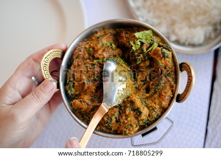 Lamb with spinach, close up of tasty indian food on light table background