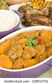 Lamb And Sweet Potato Peanut Stew Served With White Rice. Jerk Chicken And Grilled Pineapple On Background. Caribbean And West African Traditional Dishes.