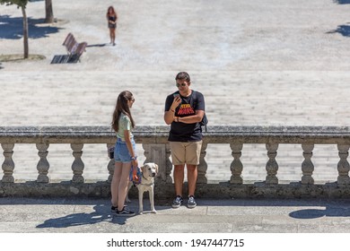 Lamego Portugal - 07 25 2019 : View of young couple taking in the stairs of Lamego Cathedral with labrador guide dog