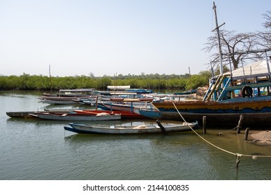 LAMIN, THE GAMBIA - FEBRUARY 6, 2022 Local Boats At Anchor Plus One Derelict Ferry