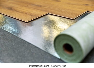 laminate floor installation in a room on foil underlay - Shutterstock ID 1600893760