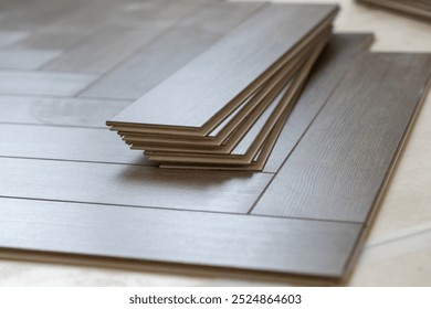 Laminate flooring installation in progress. Step-by-step laying of planks in a stylish apartment, perfect for home improvement and renovation themes