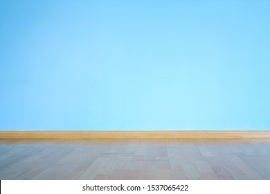 Laminate Flooring, Plinth And Large Blue Concrete Wall With Empty Space