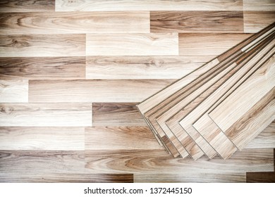 Laminated floor boards pile top view. Wooden floors work in new modern house. - Shutterstock ID 1372445150