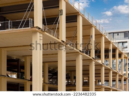Laminated wood floors and supports of a mass timber multi story green, sustainable, residential high rise apartment or office building construction project
