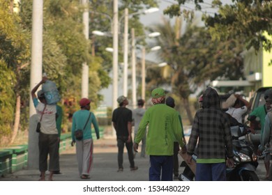 LAMONGAN, INDONESIA - JANUARY 28, 2019: Indonesian Construction Worker Coming Home From Work