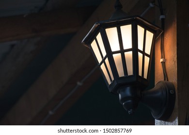 A Lamp Found Near The Porch Of A Building Giving Out Subtle Light