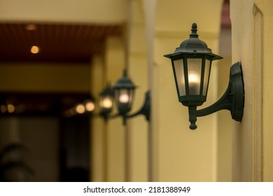 lamp light on the wall. Vintage iron lantern on the wall outdoor. Garden metal electrical lamp in a village. Wall lamp outdoor. - Powered by Shutterstock