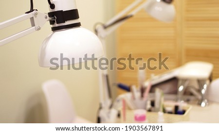 Lamp on a blurry background of nail salon. Website banner with place for text