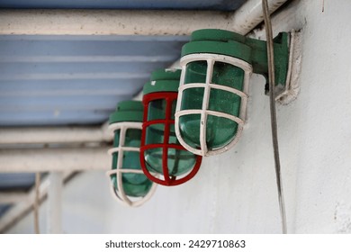 lamp on the ship's deck with a red and white steel cover. - Powered by Shutterstock