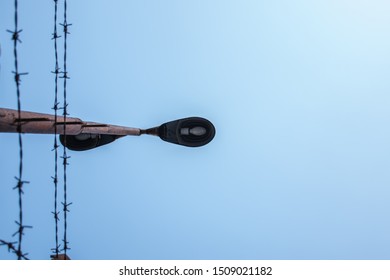 Lamp post with barbed wire