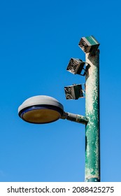 Lamp Post With Loudspeakers Against Blue Sky Close Up