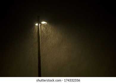 Lamp Post At Night In Heavy Snow Storm