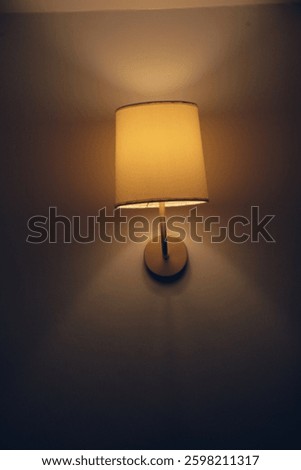 a lamp post showing an accentuated light design with shadows on the side and light protruding upward and downward