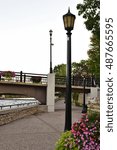 Lamp posts and bridge across the Cannon River along the river walk,, Northfield, Minnesota