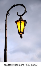 lamp, Retro nostalgic or vintage street lamp shining at night against cloudy sky with copy space