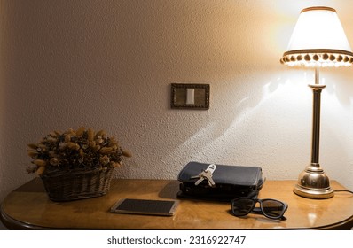 Lamp, sunglasses keys and mobile phone on a wooden furniture. Entrance hall - Powered by Shutterstock