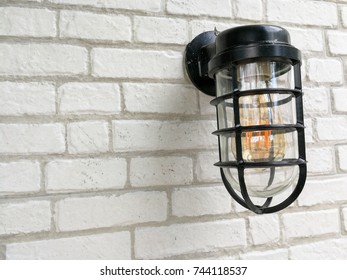 lamp and white bricks wall background.