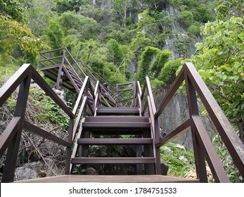 Lampang / Thailand - 25 Jul 2020: Metal walkways and stairs to reach the temple. "Phra Phutthabat Pu Pha Daeng", Lampang Province, Thailand.