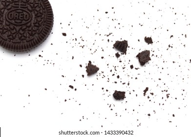LAMPHUN, THAILAND - JUNE 25, 2019: Oreo Biscuits with crumbs on white background. It is a sandwich cookies filled with chocolate cream flavored. The best selling dessert in Thailand.