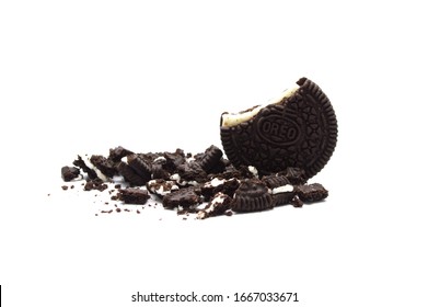 LAMPHUN, THAILAND - MARCH 3, 2020: Oreo Biscuits with crumbs isolated on white background. It is a sandwich chocolate cookies with a sweet cream is the best selling dessert in Thailand. 