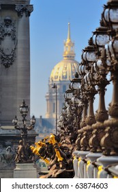 Lampposts on the bridge and the golden Dome of the Cathedral