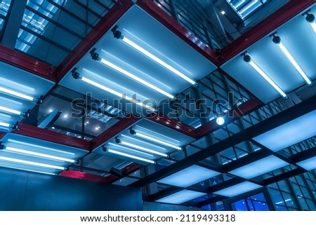 Lamps with diode lighting under the ceiling of a modern exhibition hall