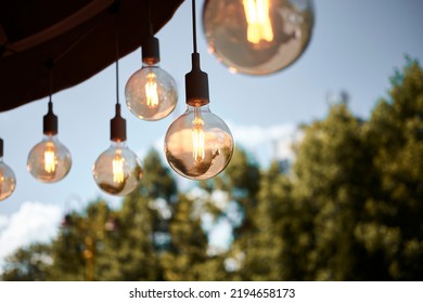 Lamps hang in the yard. Terrace concept. - Powered by Shutterstock